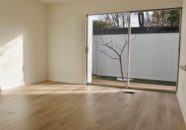 empty room with wood finished floors and baseboards