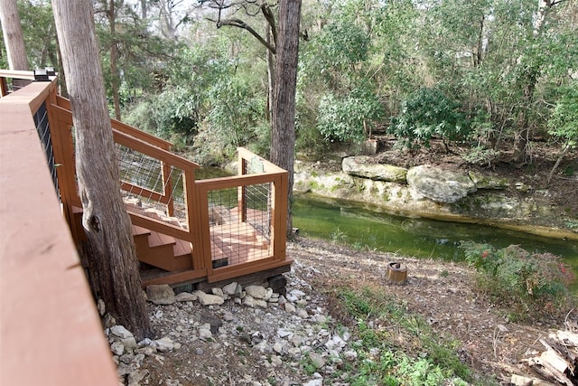 wooden deck with a view of trees