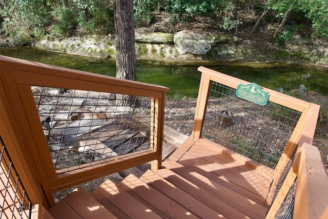 wooden deck with a water view