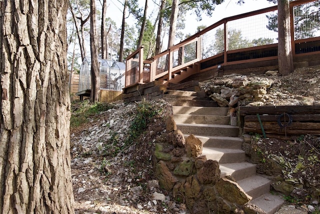 view of side of home featuring stairs