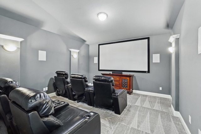 carpeted cinema room featuring baseboards