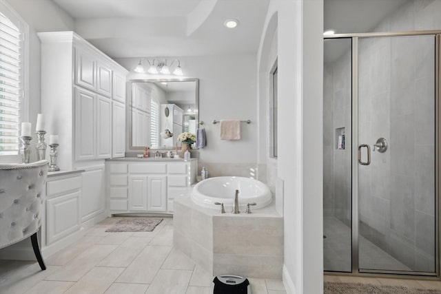 bathroom with tile patterned flooring, a shower stall, vanity, and a bath