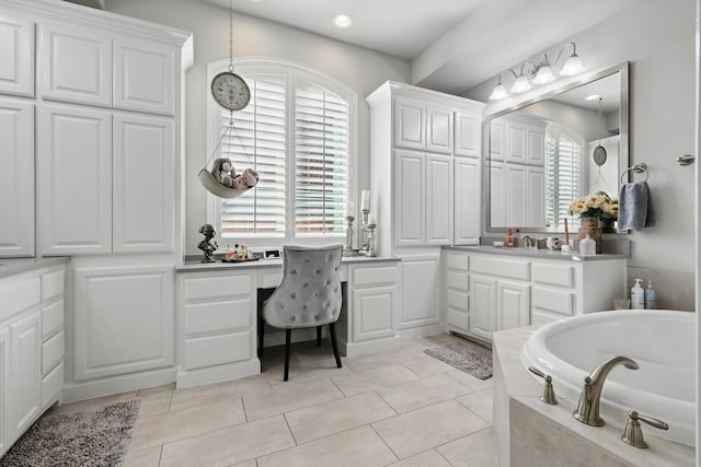 full bathroom featuring tile patterned flooring, a washtub, and vanity