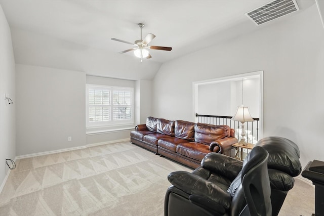 carpeted living area with lofted ceiling, baseboards, visible vents, and a ceiling fan