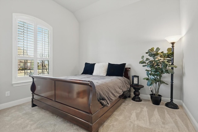 bedroom with carpet floors, baseboards, and vaulted ceiling