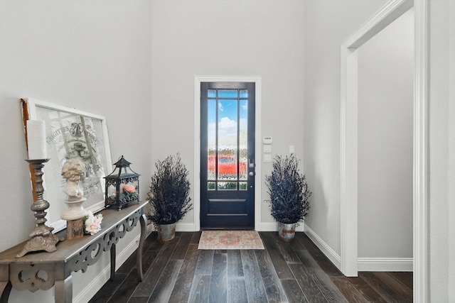 foyer featuring dark wood-style floors and baseboards