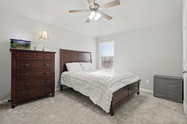 bedroom featuring light carpet, a ceiling fan, and baseboards