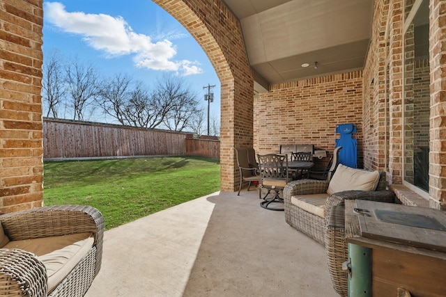 view of patio with outdoor dining area and a fenced backyard