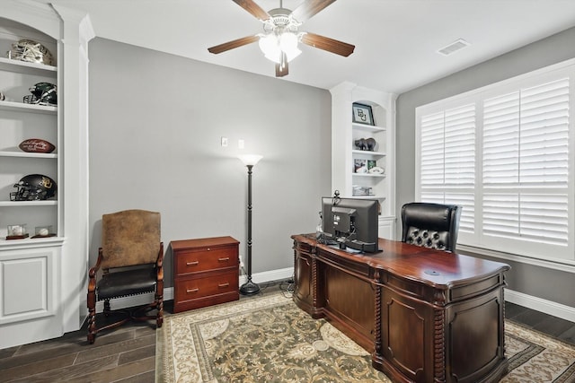 office area with a ceiling fan, visible vents, baseboards, and wood finished floors