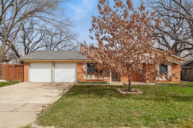 view of front of property featuring an attached garage, brick siding, fence, concrete driveway, and a front yard