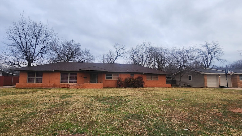 view of front facade with brick siding and a front yard