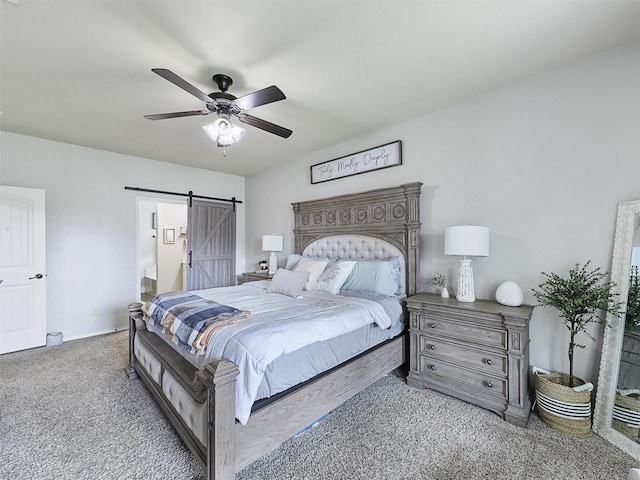 bedroom featuring carpet floors, a barn door, baseboards, and ceiling fan