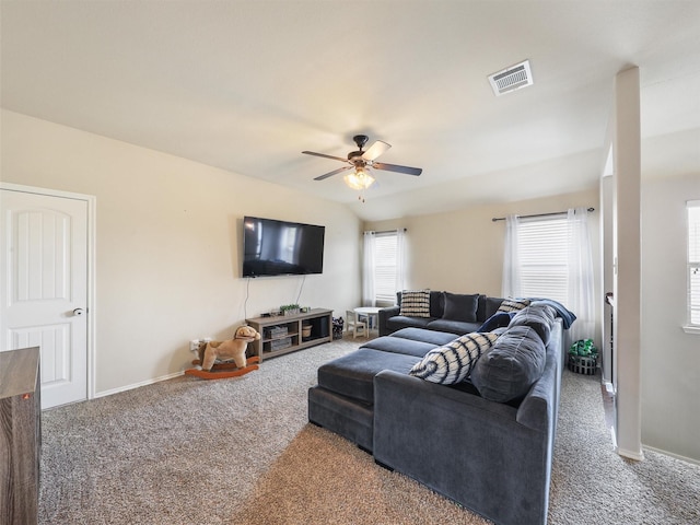 carpeted living area featuring visible vents, ceiling fan, and baseboards