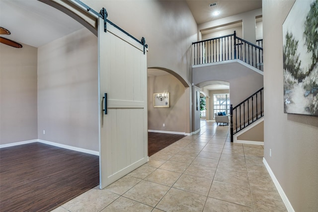321 Westlake, Forney, TX 75126 - tiled foyer entrance with stairway, an inviting chandelier, arched walkways, a high ceiling, and baseboards