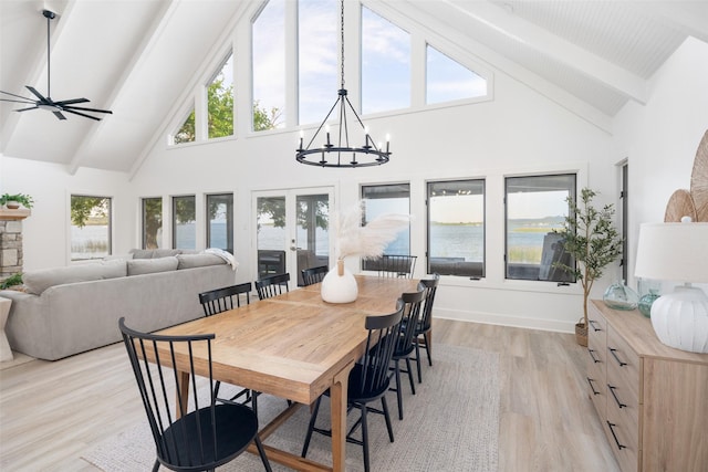 dining room featuring light wood-type flooring, beam ceiling, and a healthy amount of sunlight