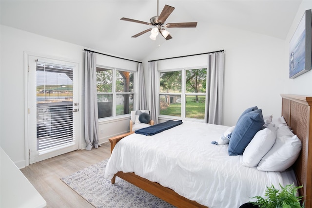 bedroom with light wood-type flooring, access to outside, vaulted ceiling, and a ceiling fan