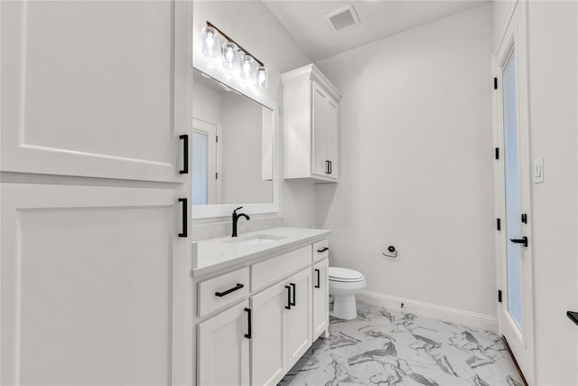 bathroom featuring visible vents, baseboards, toilet, marble finish floor, and vanity