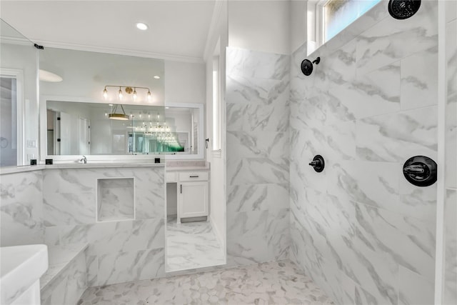 bathroom featuring marble finish floor, a marble finish shower, crown molding, and vanity