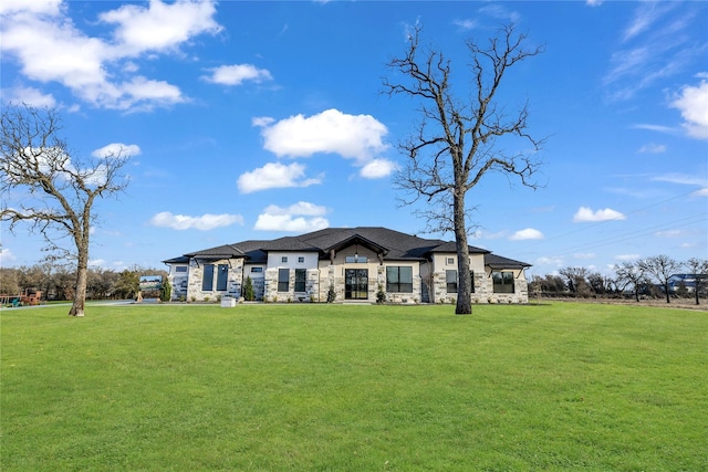 view of front of home featuring stone siding and a front lawn