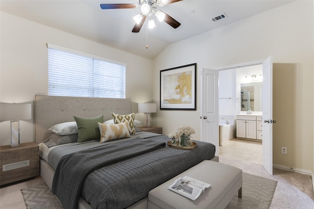 bedroom featuring lofted ceiling, connected bathroom, light carpet, visible vents, and a ceiling fan