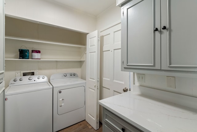 washroom featuring dark wood-style floors, ornamental molding, independent washer and dryer, and cabinet space