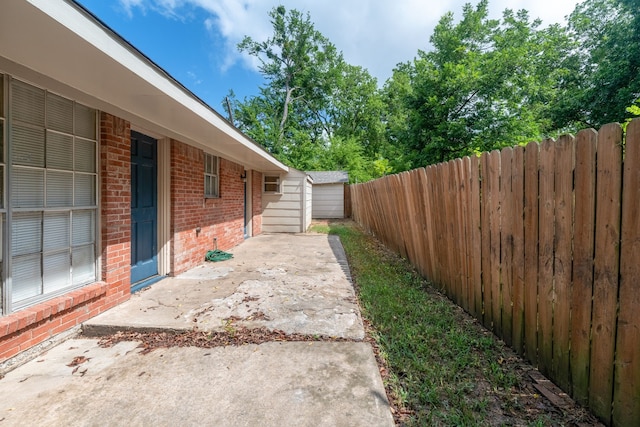 exterior space with a patio area, brick siding, and a fenced backyard