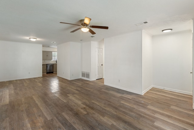 unfurnished living room featuring baseboards, ceiling fan, visible vents, and dark wood-style flooring