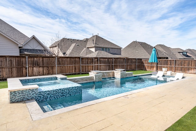 view of pool featuring a patio area, a fenced backyard, and a pool with connected hot tub