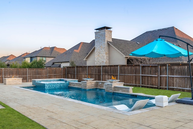 view of swimming pool with a patio area, a fenced backyard, and a pool with connected hot tub