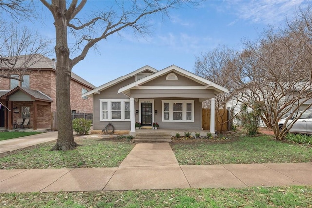 bungalow-style home with fence and a porch