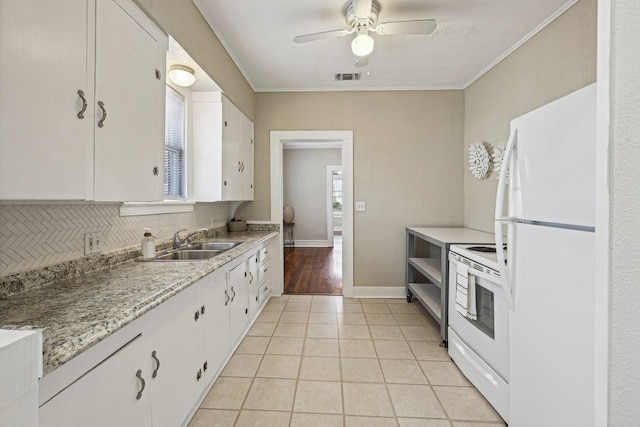 kitchen with light tile patterned floors, visible vents, white cabinetry, a sink, and white appliances