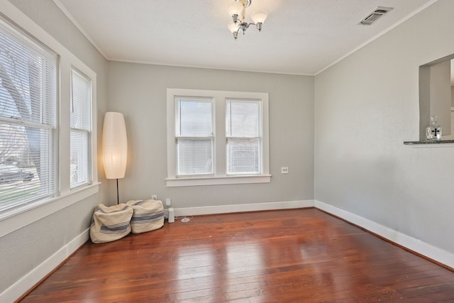 sitting room with baseboards, visible vents, hardwood / wood-style floors, and ornamental molding