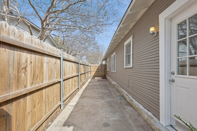 view of home's exterior with a patio area and fence