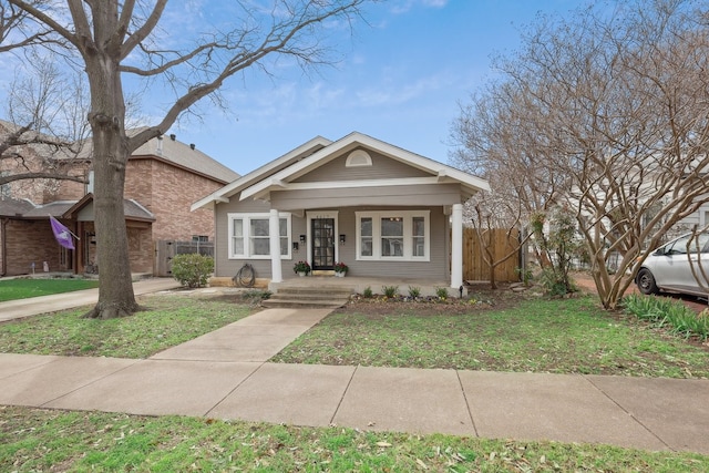 bungalow-style house with fence and a porch