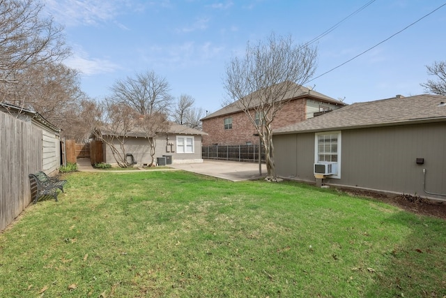 view of yard featuring a patio, central AC unit, an outdoor structure, and a fenced backyard