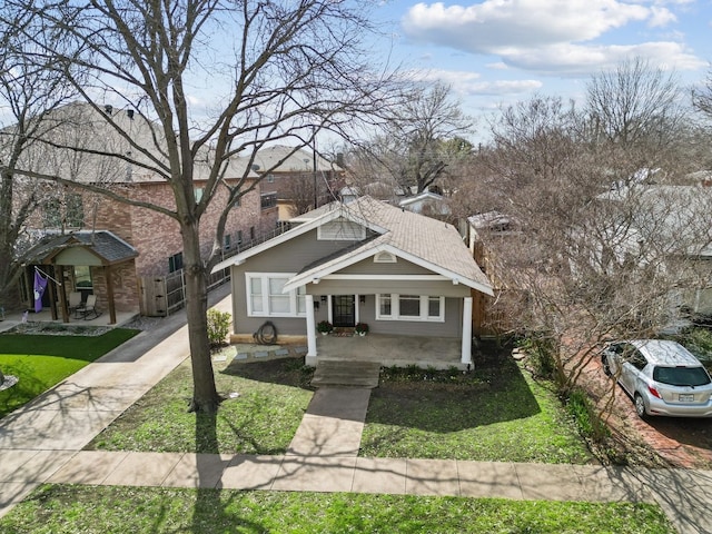 bungalow-style home featuring a porch and a front yard