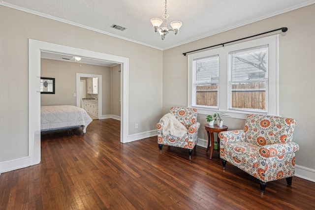 sitting room featuring an inviting chandelier, visible vents, baseboards, and hardwood / wood-style flooring