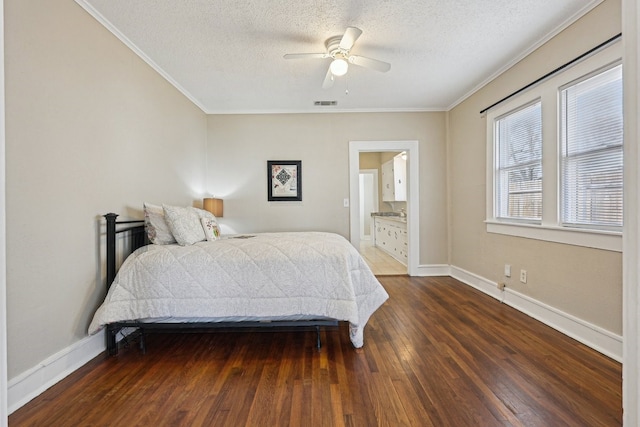 bedroom with a textured ceiling, visible vents, baseboards, hardwood / wood-style floors, and crown molding