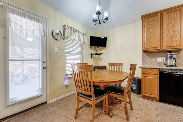 dining space with light tile patterned floors, baseboards, and a notable chandelier