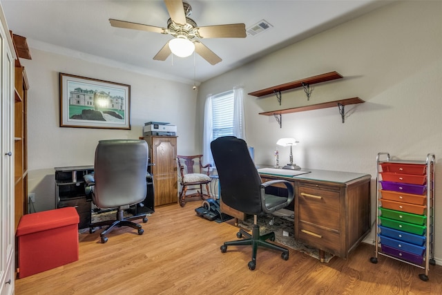 office space with a ceiling fan, visible vents, and wood finished floors