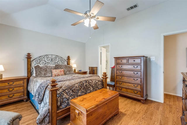 bedroom featuring light wood-style floors, visible vents, vaulted ceiling, and a ceiling fan