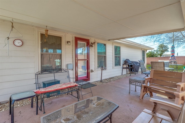 view of patio with outdoor dining area and fence