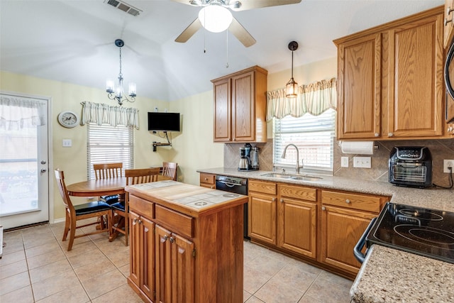 kitchen with brown cabinets, visible vents, and a sink