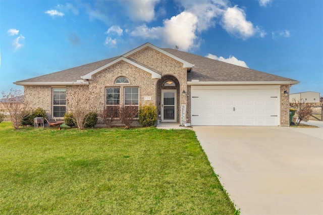 ranch-style home with driveway, an attached garage, a front yard, and brick siding