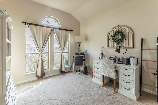 office space featuring lofted ceiling, light colored carpet, and baseboards