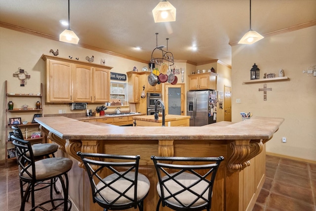 kitchen featuring a center island with sink, light countertops, appliances with stainless steel finishes, light brown cabinets, and a kitchen bar