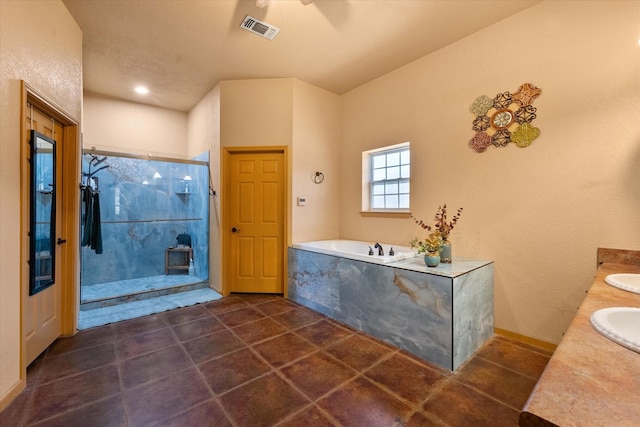 bathroom featuring a sink, visible vents, a shower stall, a bath, and double vanity