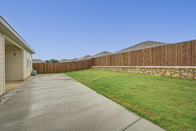 view of yard featuring a patio area and a fenced backyard