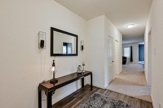 hall with wood finished floors and baseboards