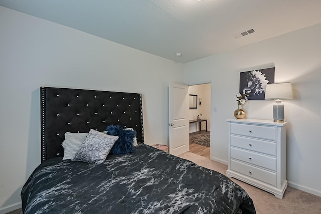 bedroom featuring light carpet, visible vents, and baseboards